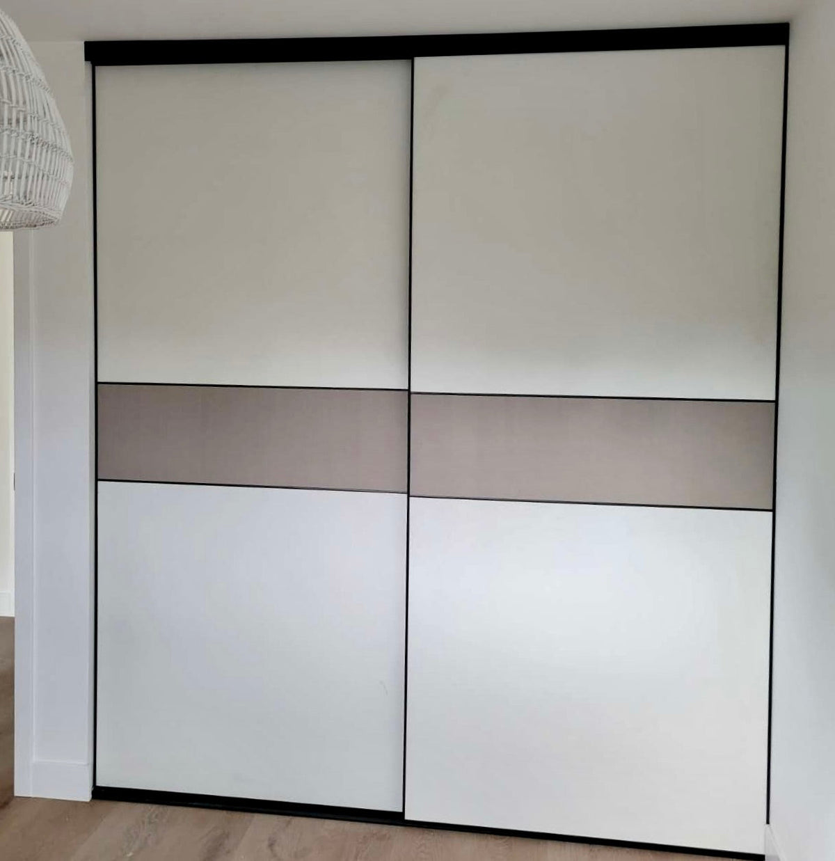 Two-tone sliding closet doors with matte black frame