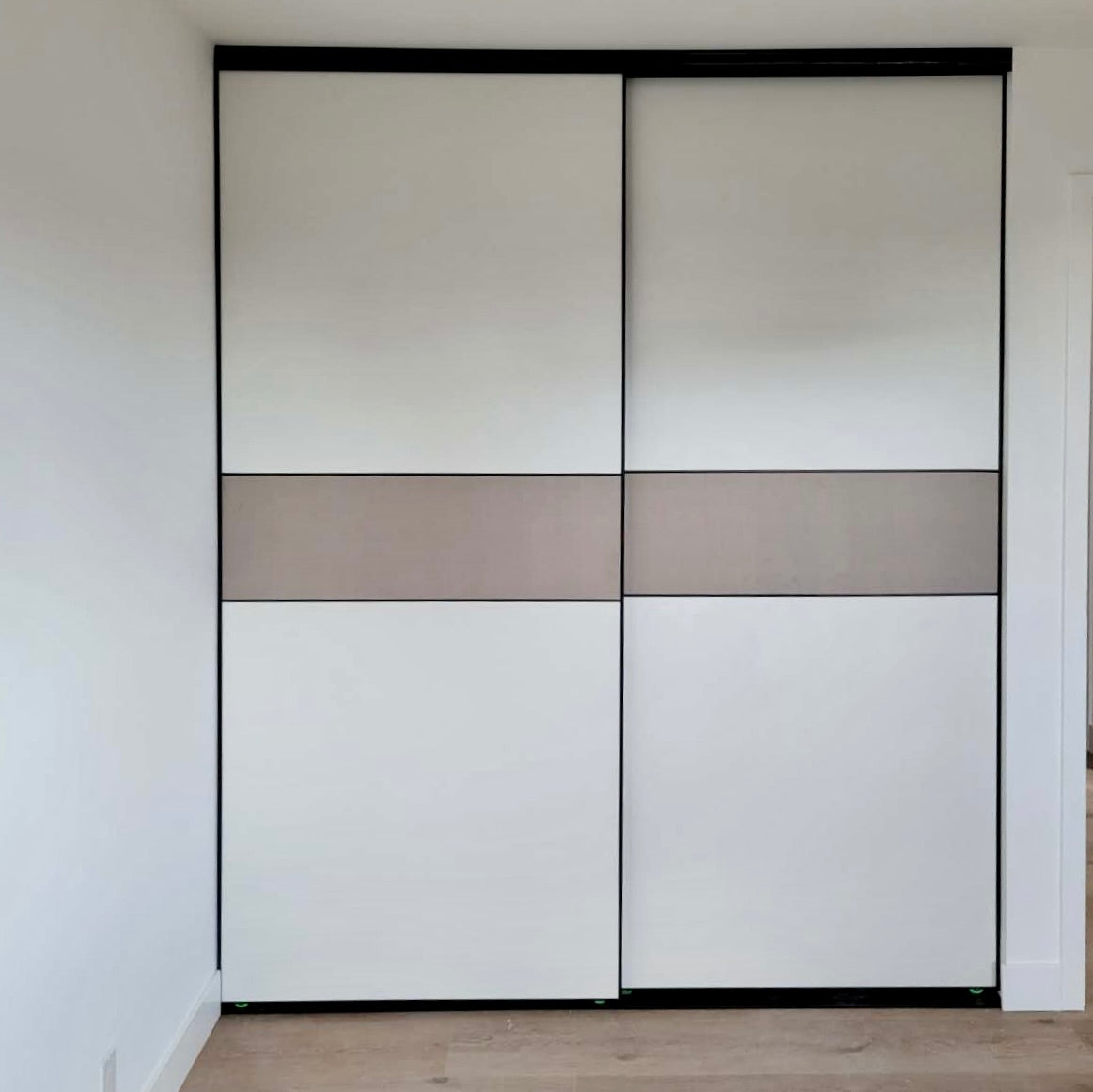 White and greige wood-grain bypass closet doors, front view
