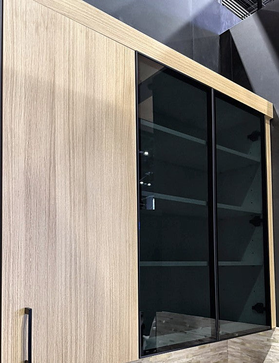 Ultimate Euro Natural White Oak wall cabinet next to double Tinted Glass wall cabinets with black aluminum frames