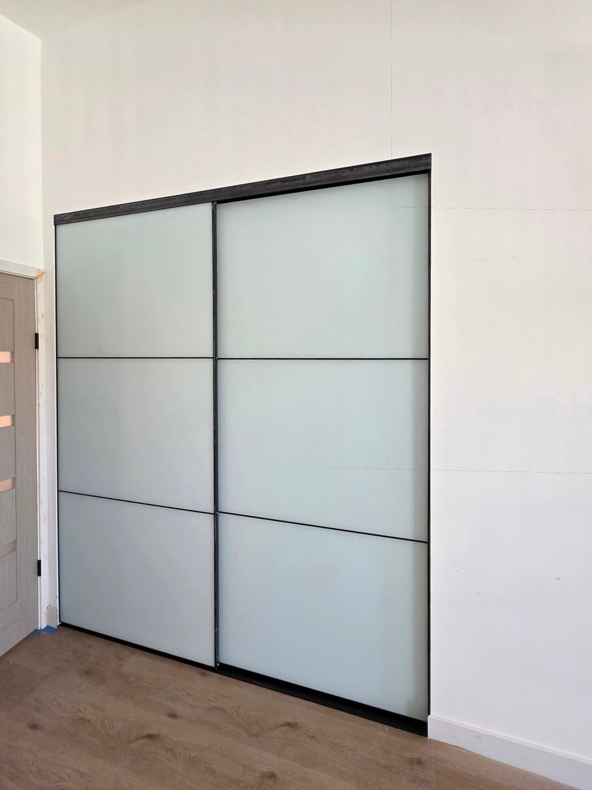 White glass sliding closet doors, side view