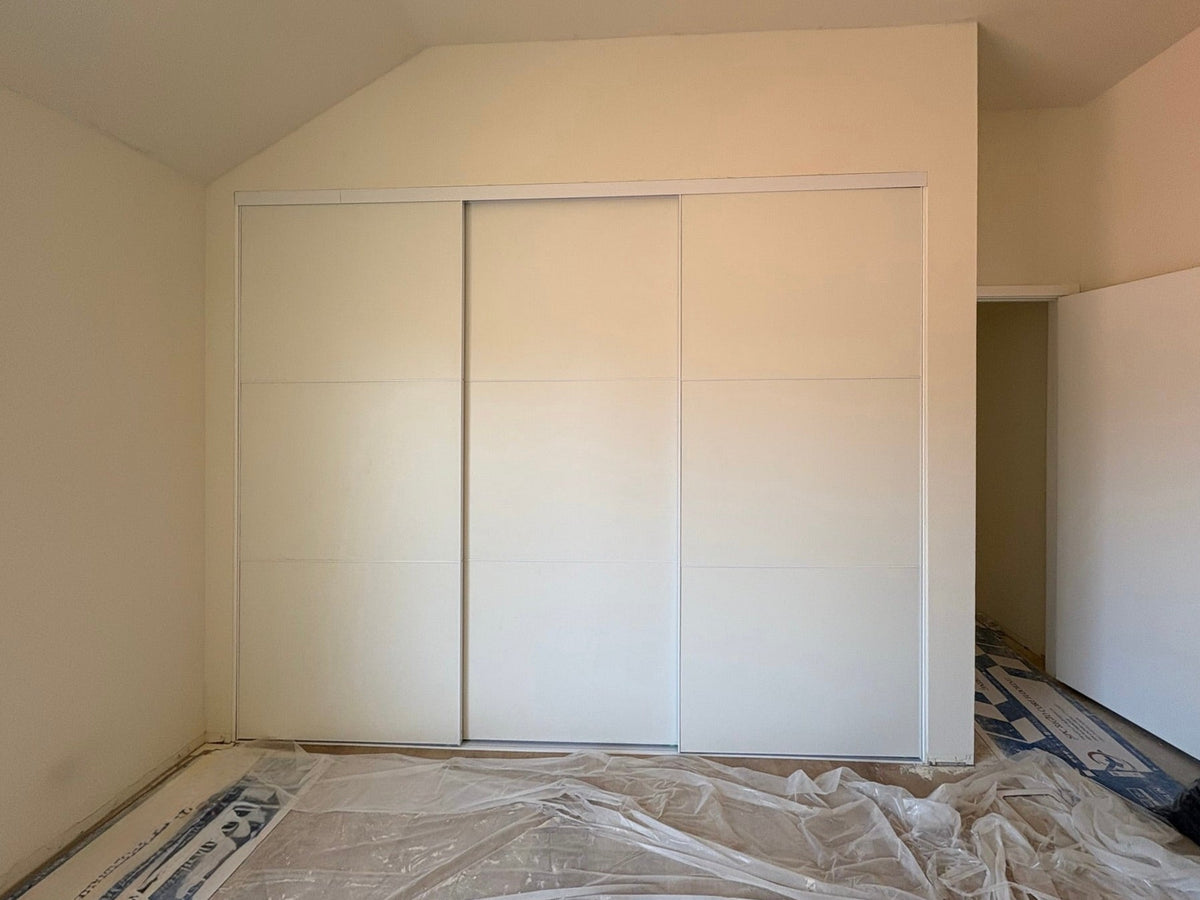 White panel sliding closet doors in new construction