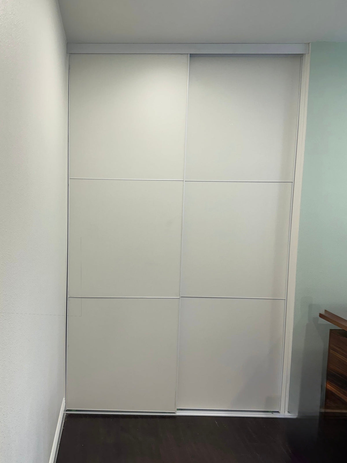White panel sliding closet doors with white frame