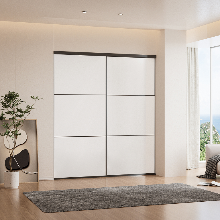 White panel sliding closet doors with black aluminum frame in a bedroom