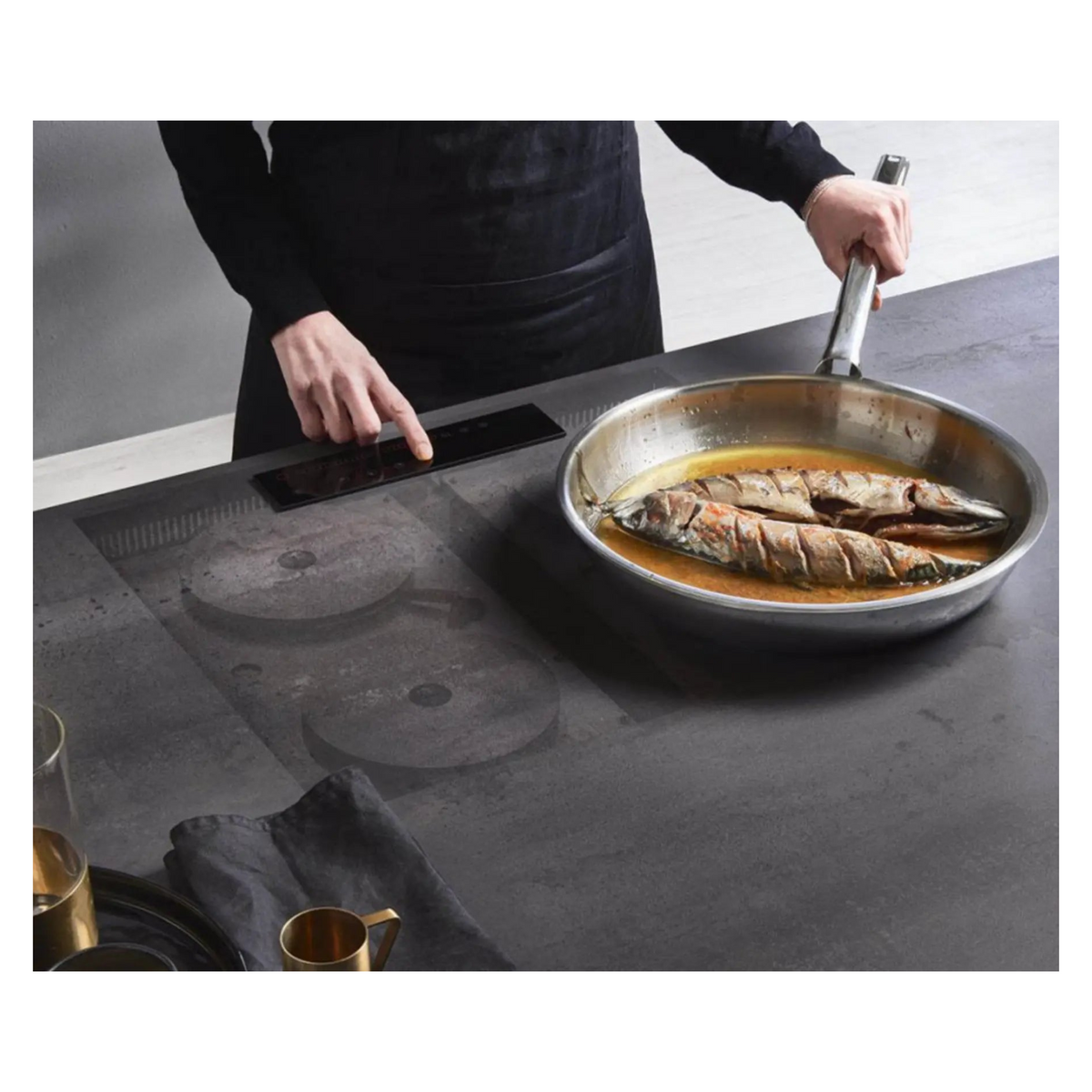 Invisacook invisible cooktop in use on a dark porcelain kitchen countertop